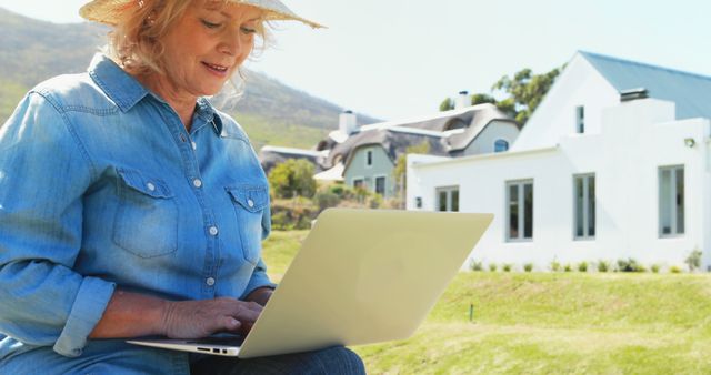 Senior Woman Working on Laptop Outside a Rural Home - Download Free Stock Images Pikwizard.com