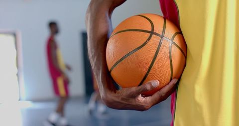 Close-Up of Athlete Holding Basketball in Indoor Court - Download Free Stock Images Pikwizard.com