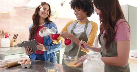 Diverse Female Friends Enjoying Baking in Modern Kitchen