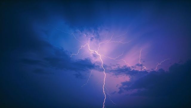 Vivid lightning bolt illuminating stormy night sky