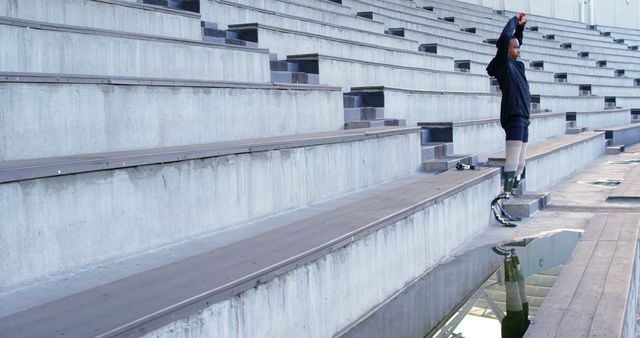 Athlete with Prosthetics Stretching in Empty Stadium - Download Free Stock Images Pikwizard.com