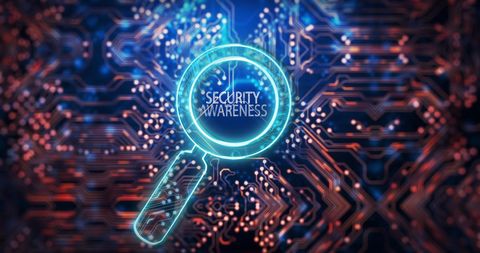 Magnifying glass highlights security awareness on circuit board