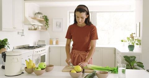 Mid Adult Woman Preparing Healthy Meal in Modern Kitchen Setting