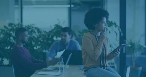 Professional Business Woman Analyzing Data on Tablet in Trendy Office