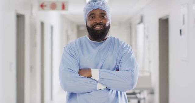 Image portrait of smiling african american male doctor in surgical cap and gown, copy space. Hospital, medical and healthcare services.
