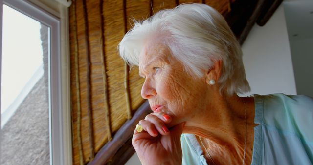 Thoughtful Elderly Woman Looking Out Window - Download Free Stock Images Pikwizard.com