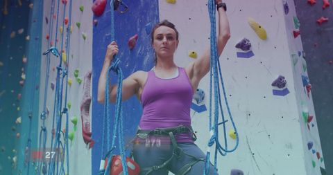 Woman Determined on Indoor Climbing Wall