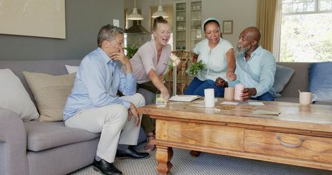 Happy Seniors Sharing Gifts and Laughter in Cozy Living Room