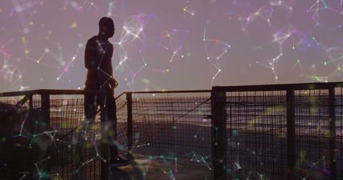 Silhouette of Man Running with Digital Network Overlay at Sunset