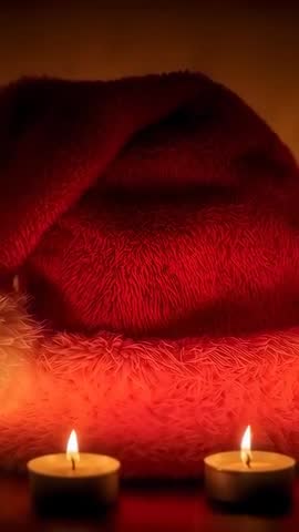 Burning tealights casting warm glow on plush red cushion vertical video for holiday ambience