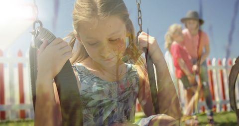 Young Girl on Swing in Sunny Backyard with Family - Download Free Stock Images Pikwizard.com