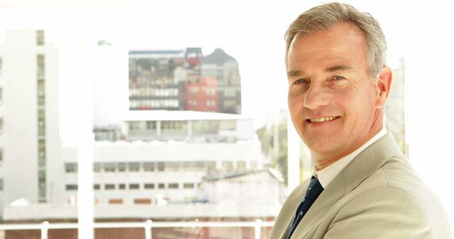 Confident Middle-Aged Businessman Smiling in Modern Office - Download Free Stock Images Pikwizard.com