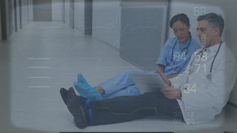 Doctors Analyzing Data in Hospital Corridor with Tech Interface