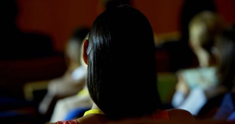 Businesswoman in Red Dress Attending Seminar Confidently