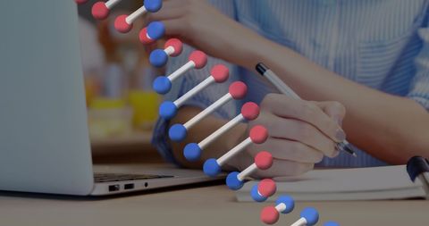 Businesswoman Analyzing DNA Data with Laptop and Notebook - Download Free Stock Images Pikwizard.com