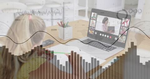 Young girl writing at home while attending virtual class on laptop with data overlay