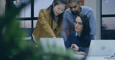 Diverse Team Collaborating Around Workplace Meeting Table