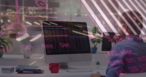 Man Analyzing Data on Monitor with Digital Overlay