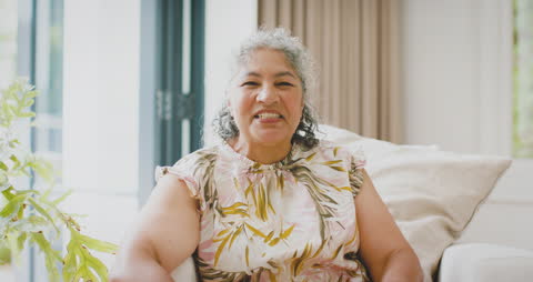 Senior Woman with Curly Gray Hair Smiling at Home