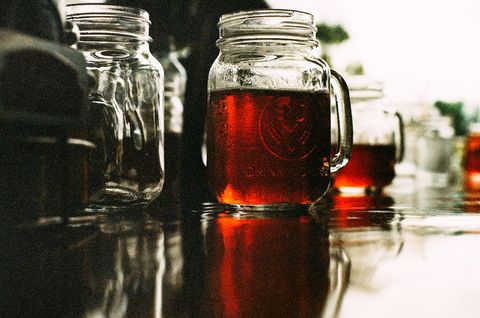 Rustic glass mason jars with glowing amber liquid
