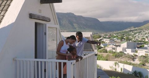 Diverse Family Enjoying Scenic View from House Balcony