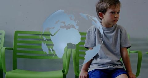 Child sitting in waiting room with earth globe overlay