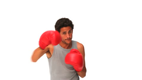 Man Practicing Boxing with Red Gloves on White Background