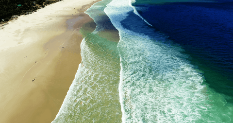 transparent waves crashing on pristine sandy shoreline - Download Free Stock Videos Pikwizard.com