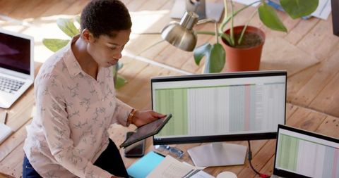 Focused Businesswoman in Plant-Filled Office Using Technology - Download Free Stock Images Pikwizard.com