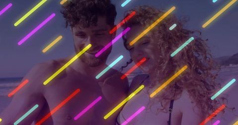 Couple smiling at sunlit beach with colorful neon streaks, summer romance vibes
