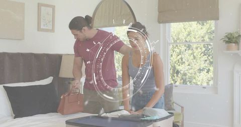 Couple packing suitcase in bright bedroom preparing weekend getaway with leather handbag