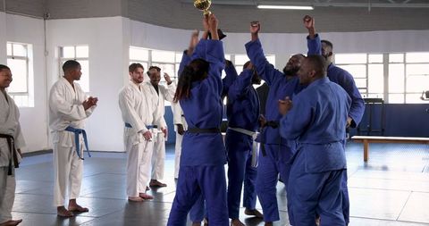 Victorious Martial Artists Celebrating in Training Hall