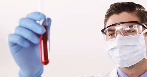 Lab Technician Examining Blood Sample with Protective Gear - Download Free Stock Images Pikwizard.com