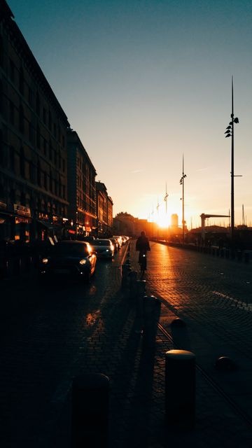 Sunset Over Urban Street with Silhouetted Bicycle Ride - Download Free Stock Images Pikwizard.com