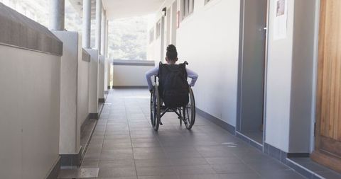 Student in Wheelchair Exploring School Hallway with Backpack - Download Free Stock Images Pikwizard.com