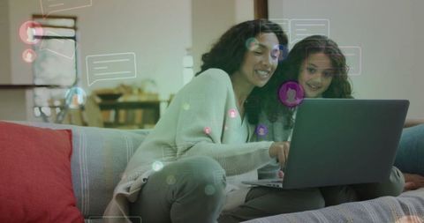 Mother and daughter enjoying digital chat from cozy living room