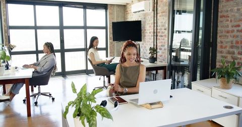 Diverse coworkers collaborating in contemporary office