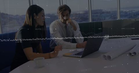 Executives analyzing data on laptop with floating digital graph