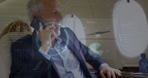 Executive businessman talking on smartphone in private jet interior