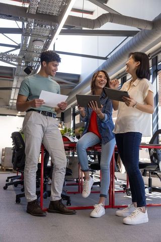 Young Professionals Collaborating in Modern Industrial Office