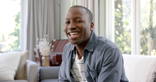 Smiling Young Man Relaxing Indoors at Home on Weekend - Download Free Stock Images Pikwizard.com