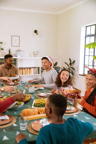 Cheerful family celebrating together around festive dining table
