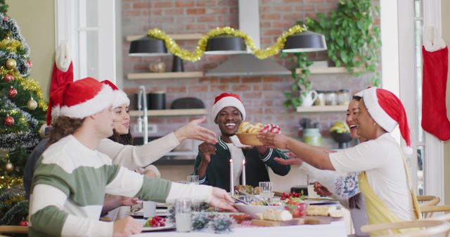 Diverse group enjoying Christmas holiday meal together in festive home - Download Free Stock Images Pikwizard.com