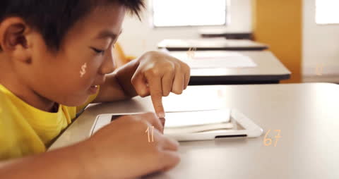 Smiling Boy Learning on Tablet in Classroom with Floating Numbers