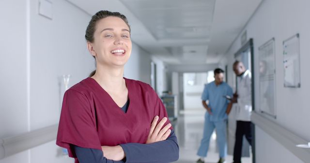 Confident Female Nurse in Hospital Corridor with Colleagues - Download Free Stock Images Pikwizard.com