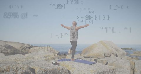 Senior African American Man Practicing Yoga on Rocky Beach with Data Overlay