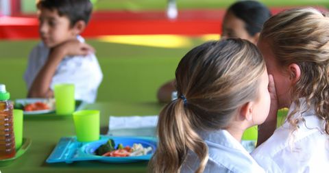 Schoolgirls Whispers and Dining in Lively Cafeteria Scene