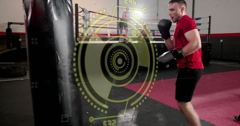 Boxer training with augmented reality hud punching heavy bag inside modern boxing gym