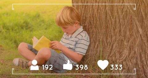 Young boy reading book outdoors with social media icons
