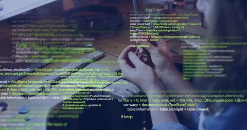 Woman coding at modern desk with laptop and tools